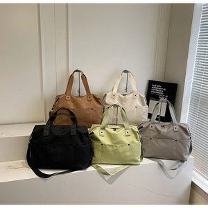 Detailed display of high-capacity fitness bags in five colors on marble surface