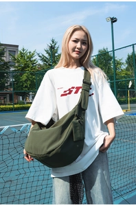 Olive green nylon crescent bag with adjustable strap and small zipper pouch attachment