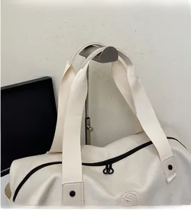 Close-up of durable woven handles and black metal zipper on off-white canvas fitness bag
