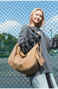 Detail of khaki nylon dumpling bag with a small matching coin purse and carabiner hook