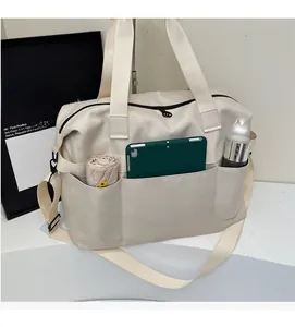Detail view of large travel bag with pockets for umbrella, tablet, and water bottle