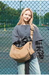 Detail view of khaki nylon hobo bag with matching mini pouch in a casual street style