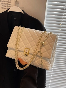 Elegant white quilted crossbody bag with gold chain strap and metal ball detail