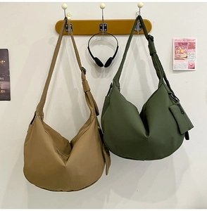 Detail of khaki and olive green nylon crescent hobo bags with adjustable straps