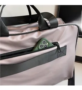 Detail of lavender oxford fabric bag featuring a zipper pocket for smartphone storage
