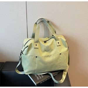 Macro shot of mint green duffel bag with durable canvas texture and sturdy handles