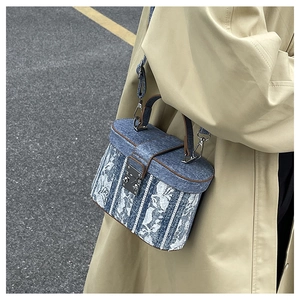 Blue denim box bucket bag with white lace floral embroidery and metal clasp