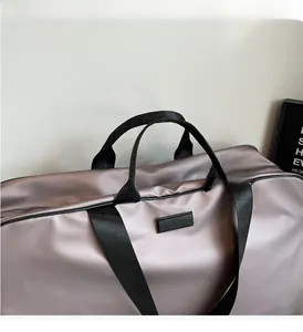 Macro detail of lavender satin travel bag with durable black nylon carry straps