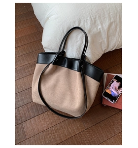 Detailed top view of large capacity tote bag with black and camel color block design