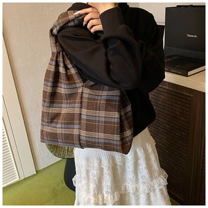Detail of classic brown plaid tote bag showing fabric texture and spacious interior