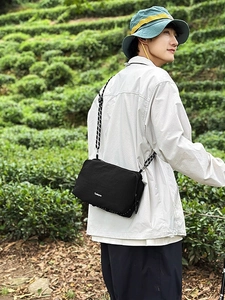 Women's black outdoor crossbody bag in nylon with woven strap for hiking and sports