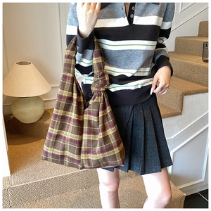 Detailed view of vintage plaid knitted tote with a unique knotted strap design