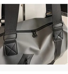 Close-up of waterproof synthetic fabric and reinforced nylon handles on travel bag