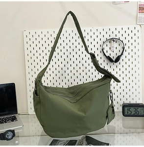 Detail of army green nylon hobo bag with adjustable strap and mini round pouch