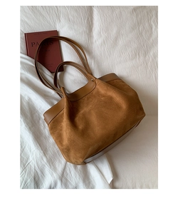 Top-down view of a brown suede tote bag with leather拼接 details and a spacious interior