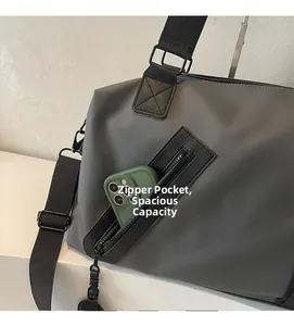 Detail of side zipper pocket on grey travel bag holding a smartphone for storage scale