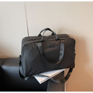 Close-up of durable black oxford fabric texture with adjustable shoulder strap and metal hooks