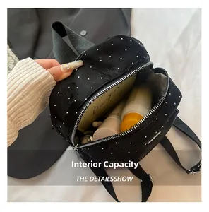 Interior view of black sequined backpack showing daily storage capacity for cosmetics