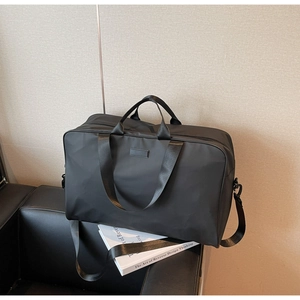 Detail of waterproof nylon travel bag with leather patch and adjustable shoulder strap