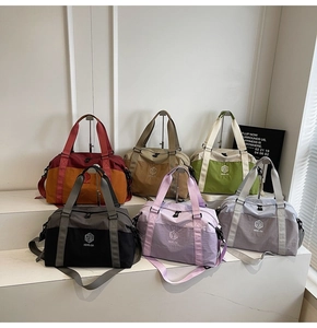 Collection of large travel duffel bags in six vibrant colors for gym and weekend trips