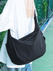 Large black nylon dumpling crossbody bag with adjustable wide strap for casual wear