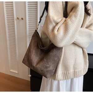 Detail of vintage brown tote bag with ethnic print strap and high texture fabric