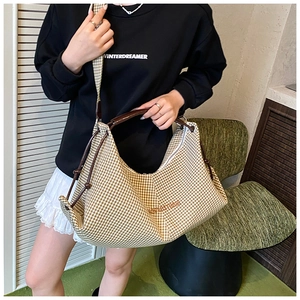 Detail of brown gingham tote bag with wide shoulder strap and drawstring accents