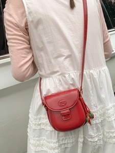 Vintage red mini saddle crossbody bag with strawberry charm and embossed logo