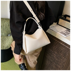 Detail of ivory lychee leather mini square bag showing texture and silver metal hardware