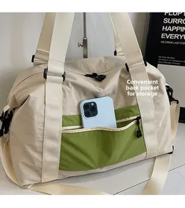 Detail of travel bag showing a green front pocket with phone storage and back sleeve