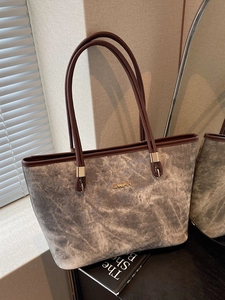 Elegant grey marble pattern tote bag with brown leather handles and gold metal hardware