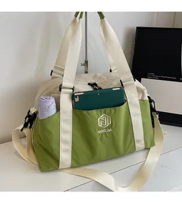 Detail of water-resistant green travel bag featuring a front pocket for tablets