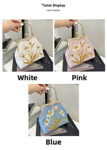 Detailed embroidery of white lilies on retro canvas handbags with metal handles