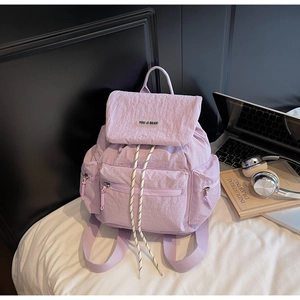 Detail view of lavender purple drawstring backpack with multiple utility pockets
