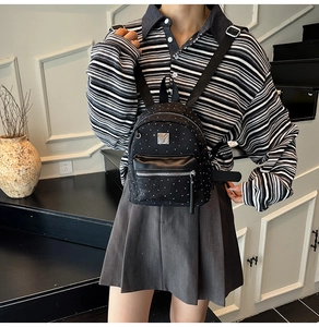 Polka dot mini backpack shown on model highlighting compact size and stylish casual wear