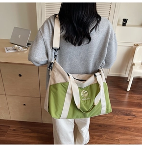 Detail showing high-capacity canvas tote bag with adjustable strap and sturdy green handle