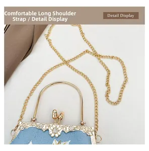 Close-up of vintage blue silk embroidery bag with golden metal frame and pearl clasp