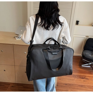 Practical black nylon large capacity business travel bag shown with an adjustable shoulder strap