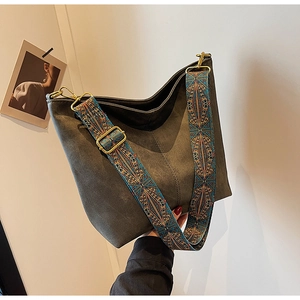 Detail of grey suede hobo bag featuring ethnic bohemian printed wide shoulder strap