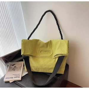 Detailed shot of neon lime green nylon tote bag featuring thick woven handle and wide strap