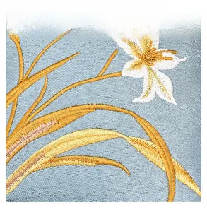 Close-up of sky blue jacquard fabric with golden and white floral embroidery