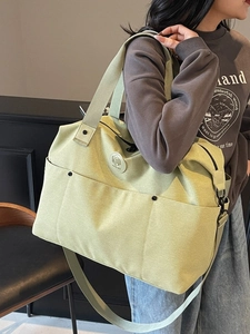 Light green canvas sports travel bag with multi-pockets and adjustable shoulder strap
