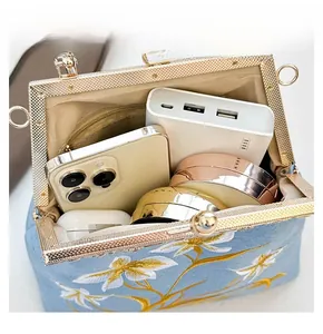 Detail display of the spacious interior of this light blue floral embroidered handbag