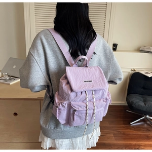 Lavender purple nylon backpack featuring multiple front pockets and drawstrings closure