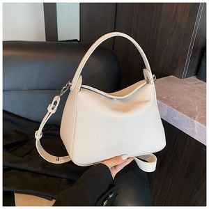 Detail of cream lychee texture leather handbag with silver hardware and top handle