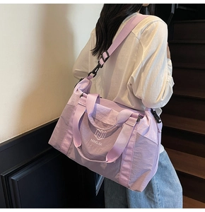 Action shot of lavender waterproof travel bag with adjustable strap and large capacity