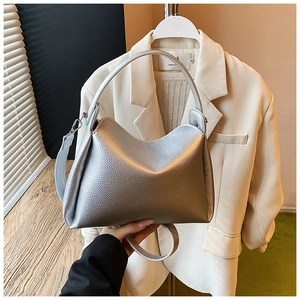 Macro detail of silver pebbled leather hobo bag with sleek metallic finish and silver hardware