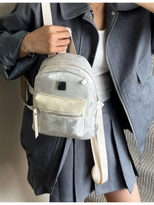 Minimalist silver-grey mini backpack for women featuring stylish wide fabric straps