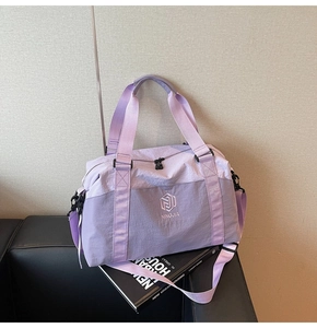 Close-up of waterproof purple travel bag on a sofa showing durable nylon texture