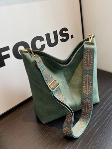 Dark green suede tote bag with a colorful retro patterned wide fabric shoulder strap